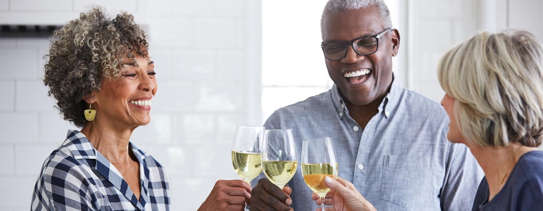 a few people toasting wine glasses