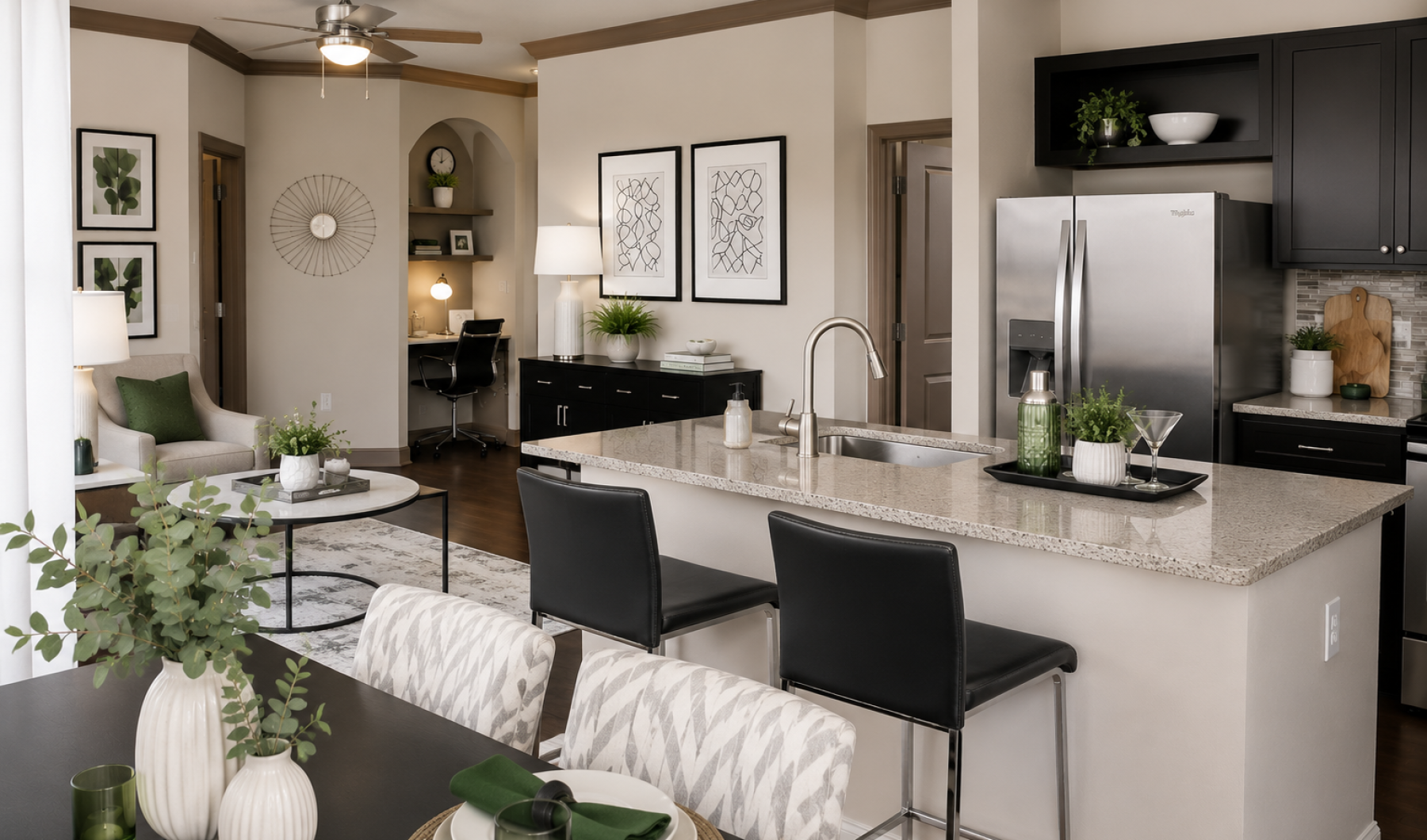 Modern open-concept apartment kitchen with white cabinetry, granite countertops, and stainless steel appliances at Stone Pointe.