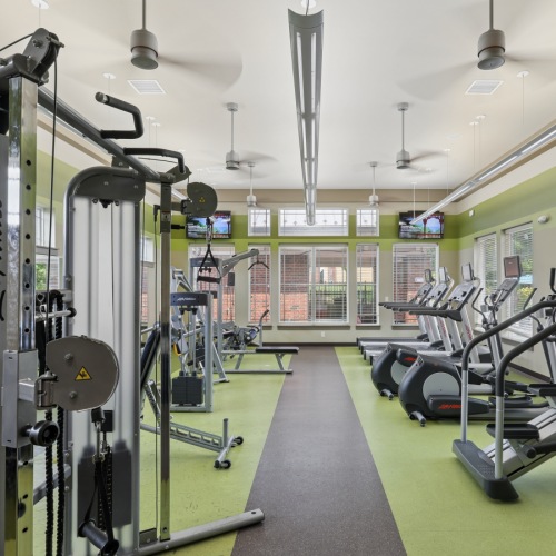 On-site fitness center at Stone Pointe apartments featuring treadmills, exercise bikes, and weight training strength equipment.